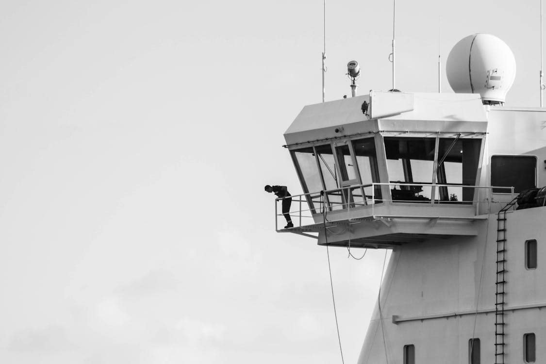 Air traffic controller at radar workstation monitoring aircraft positions on display screens