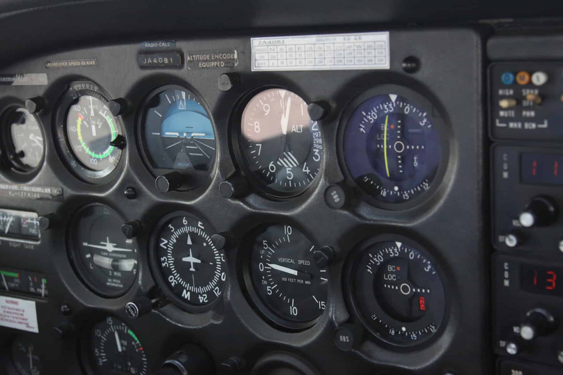 Pilot reviewing instrument panel and flight planning documents before checkride
