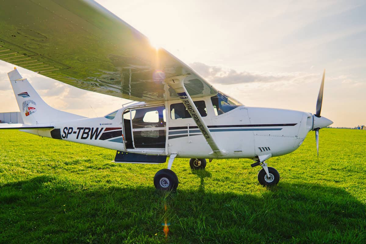 Cessna 172 taxiing on a runway at a small towered airport