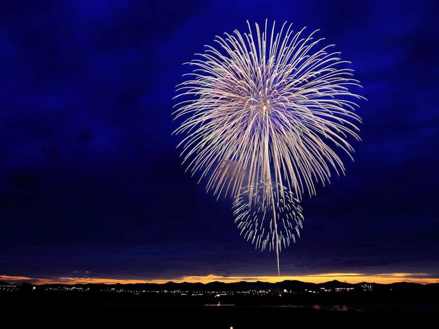 Spectacular fireworks lighting up the night sky over the water.