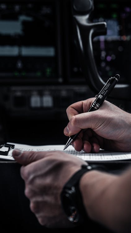 FAA new NOTAM system - pilot reviewing preflight documents and NOTAM briefing before flight