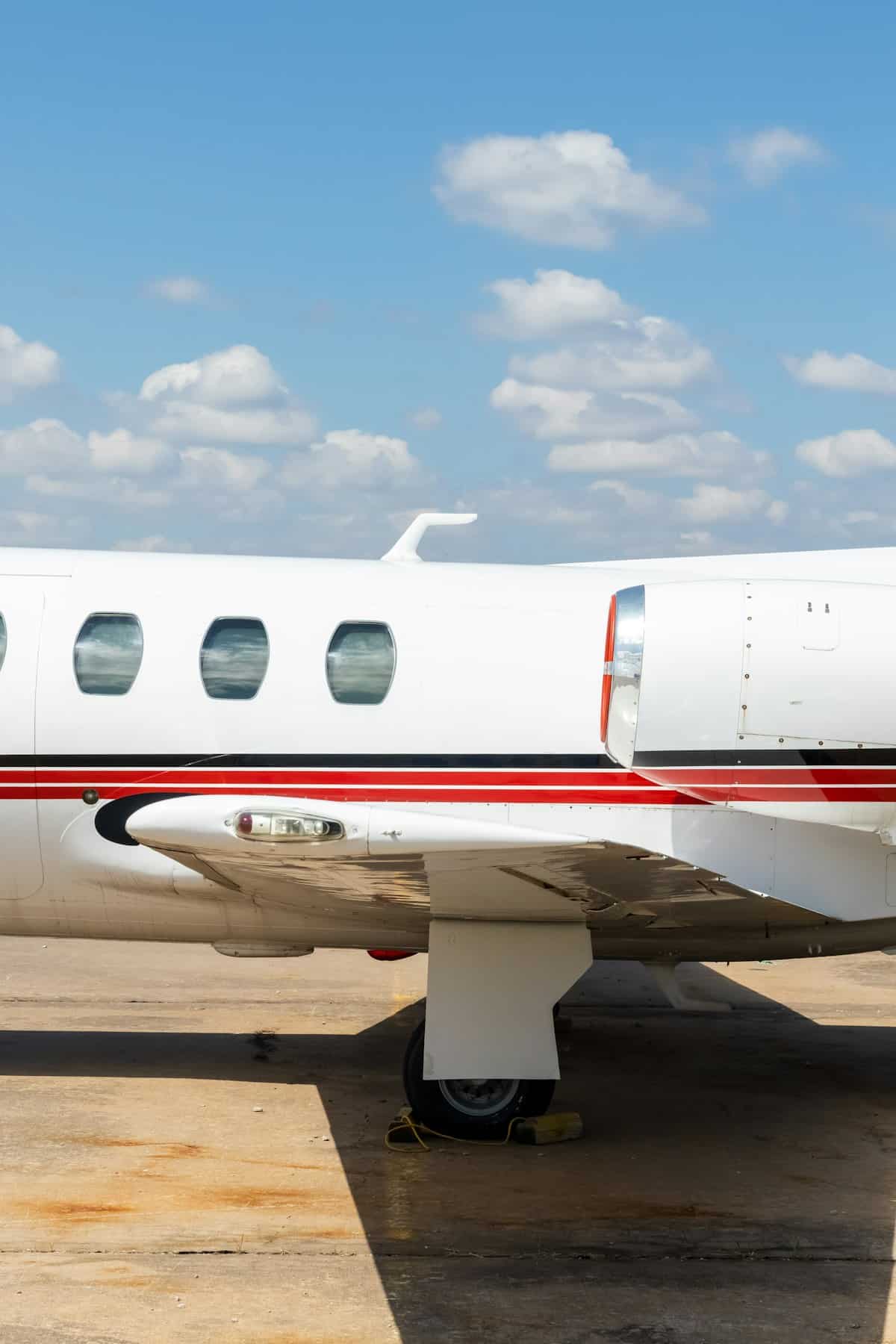 White and red general aviation airplane flying under bright blue sky in class e airspace