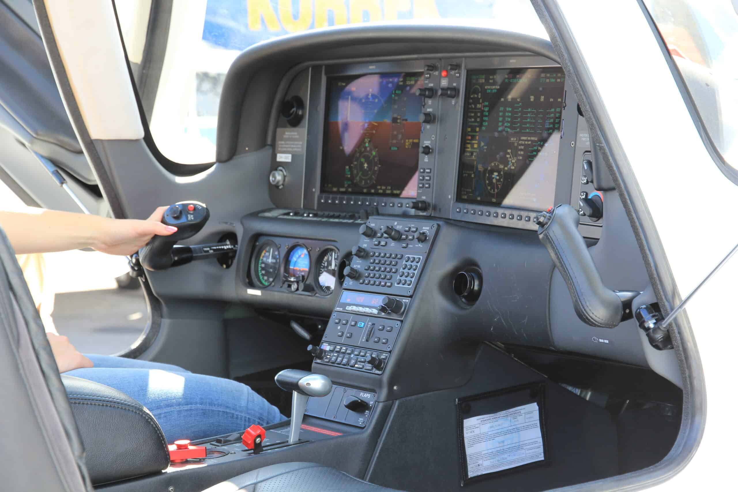 Helicopter cockpit featuring advanced avionics screens and controls for navigation and flight manage.