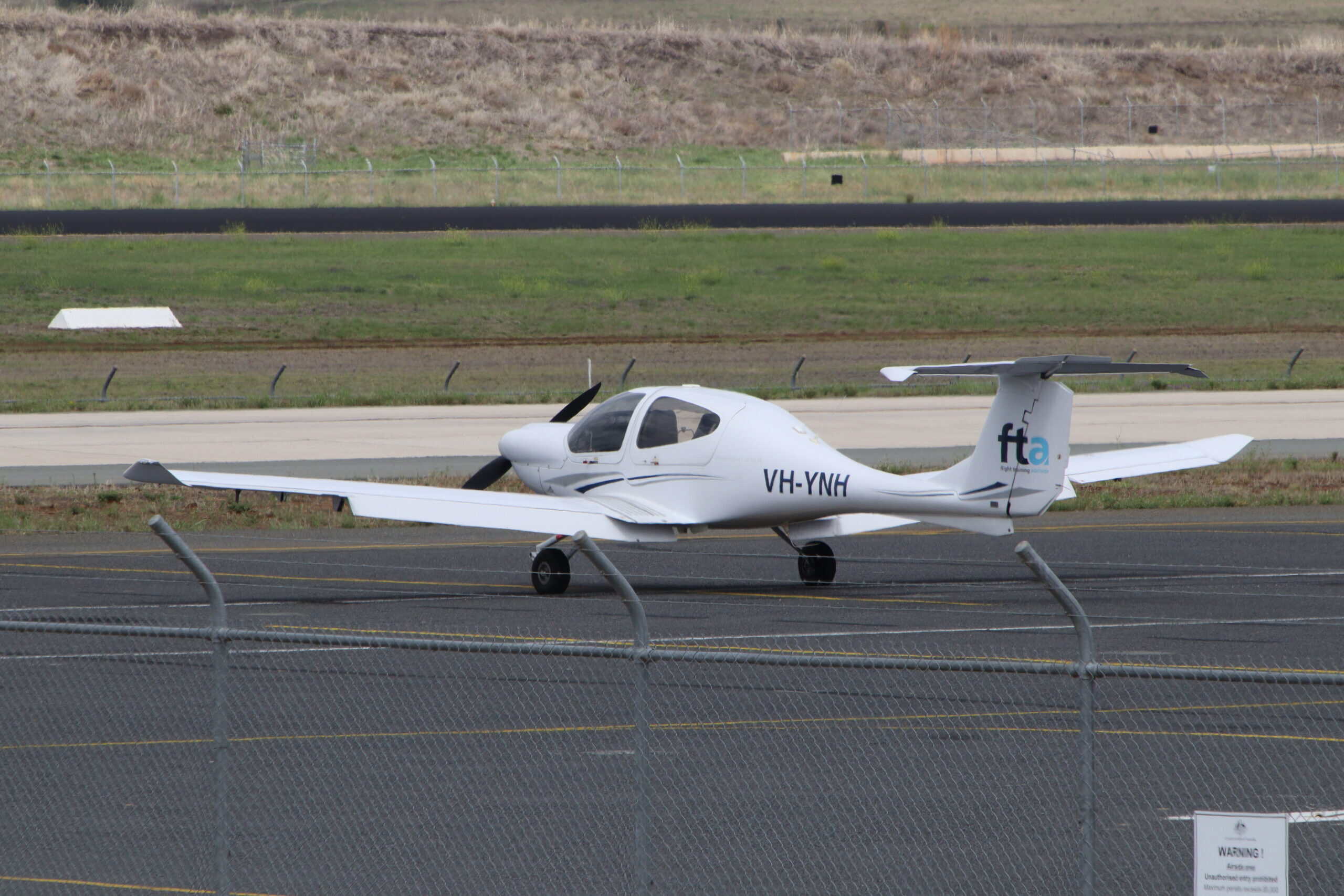 Small GA aircraft parked at airport awaiting inspection