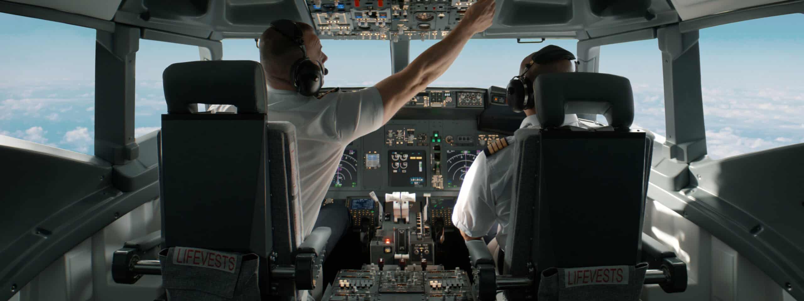 Two pilots reviewing IFR flight plan fields in the cockpit before an instrument departure