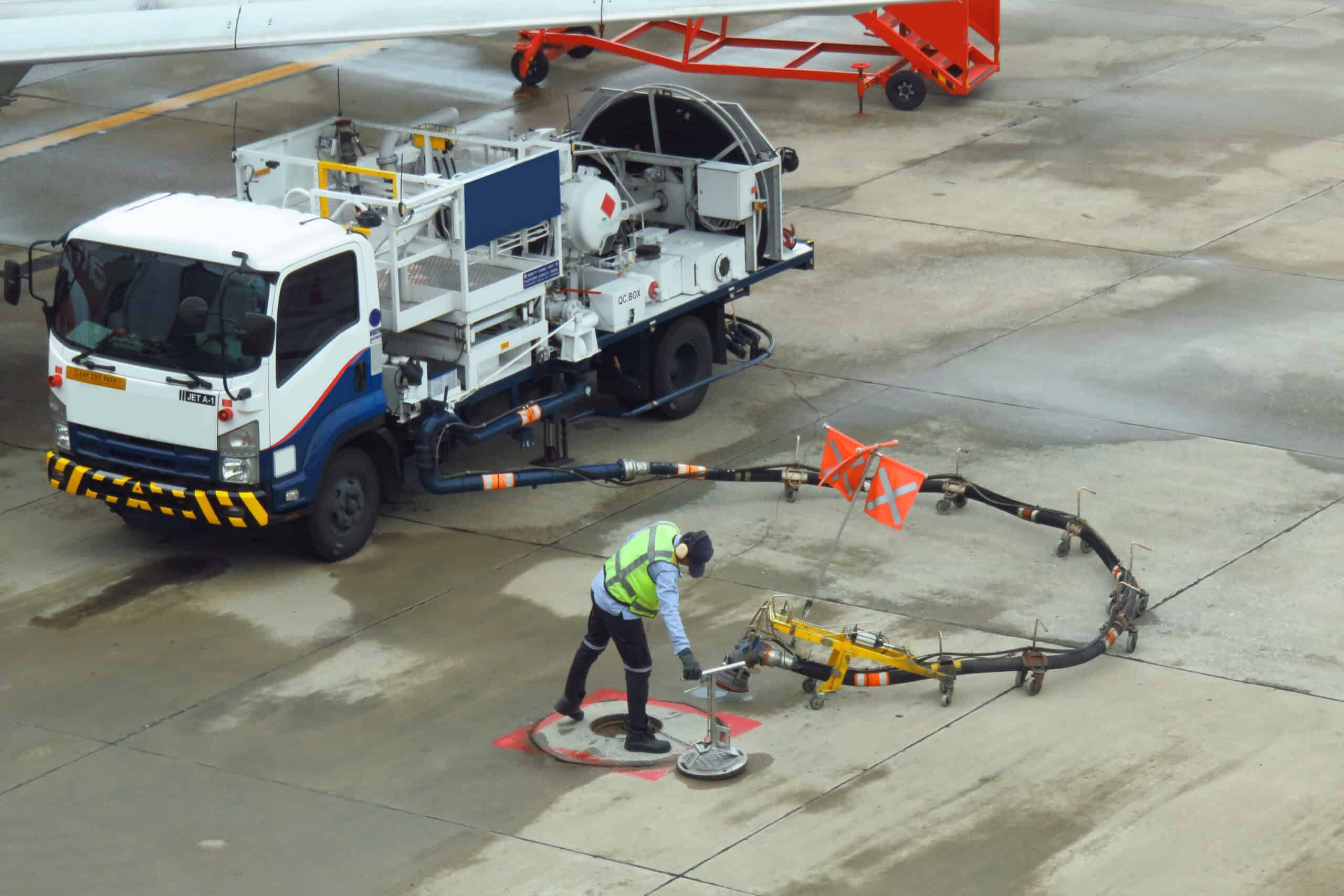 Fuel truck servicing a parked aircraft