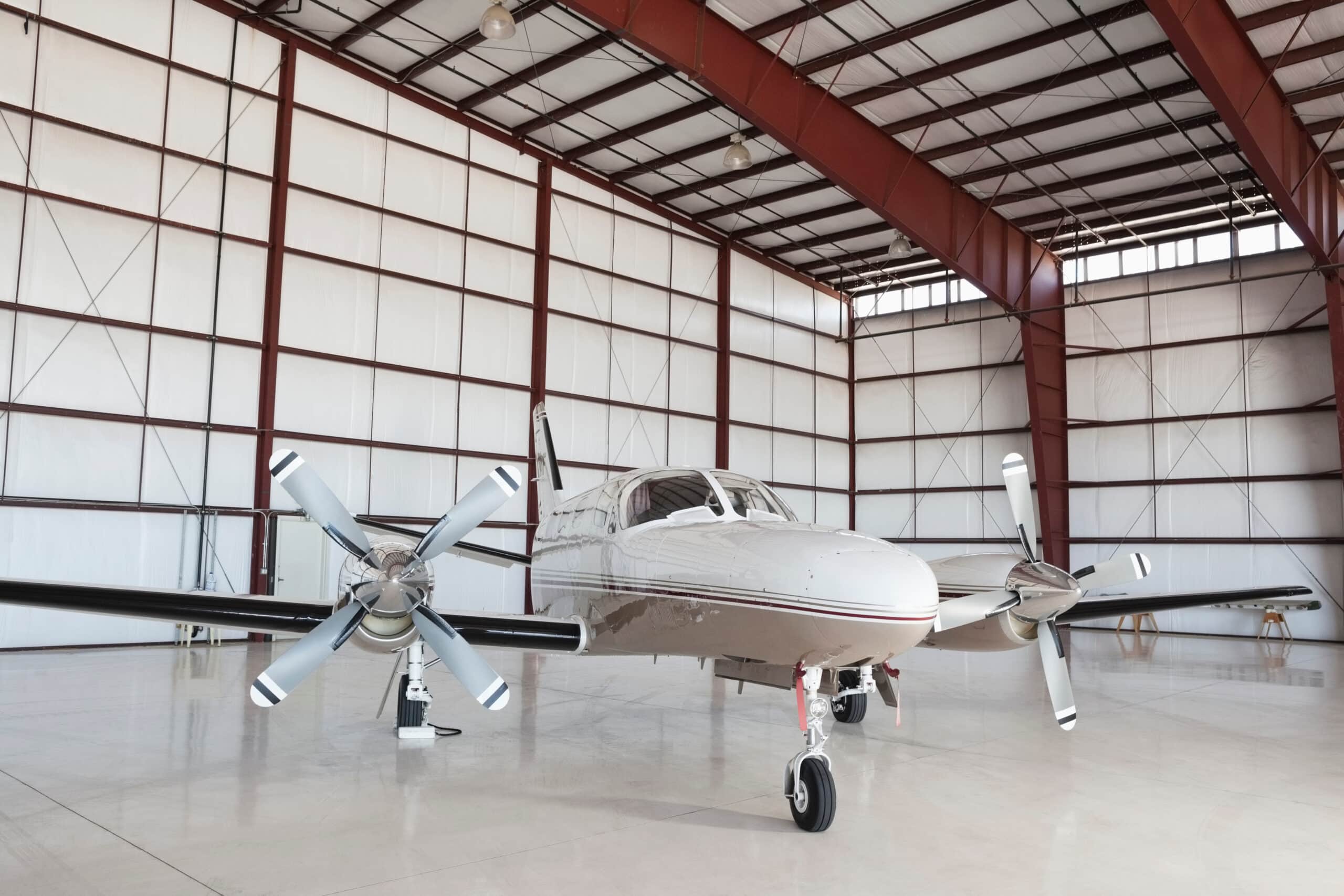 Private aircraft parked inside an aviation hangar