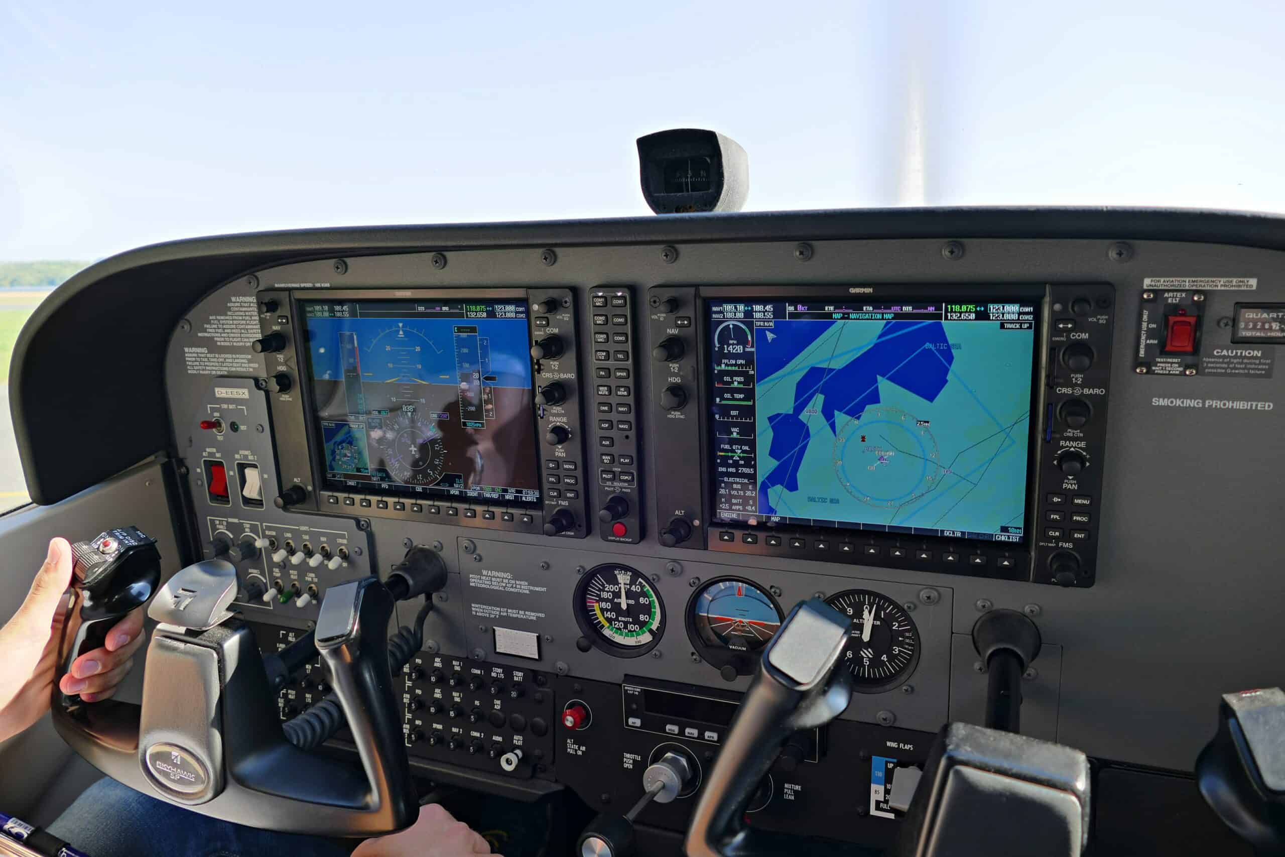 Autopilot cockpit panel with navigation screens and controls in a small aircraft.