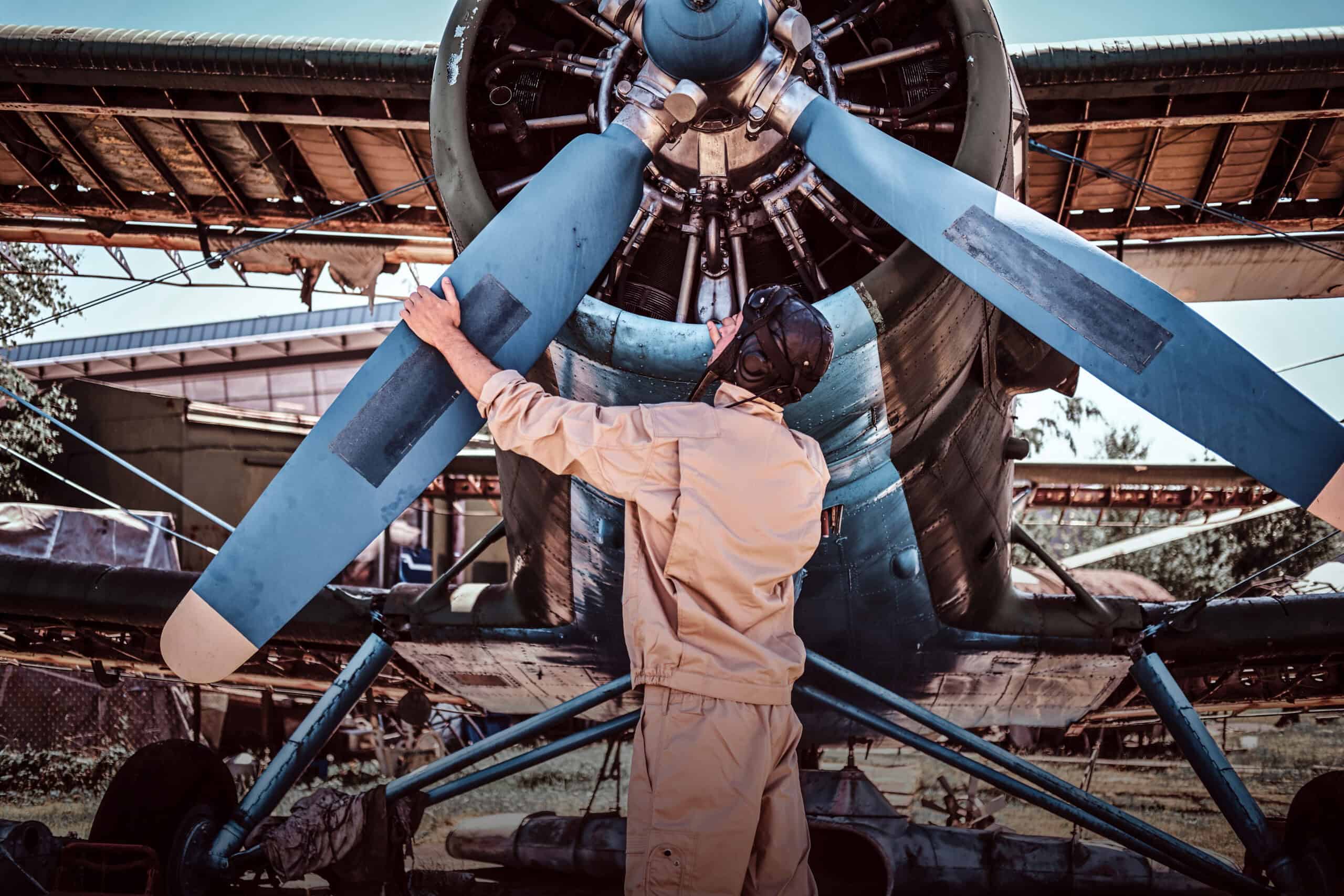 aircraft mechanic diagnosing turbo oil leak during propeller inspection
