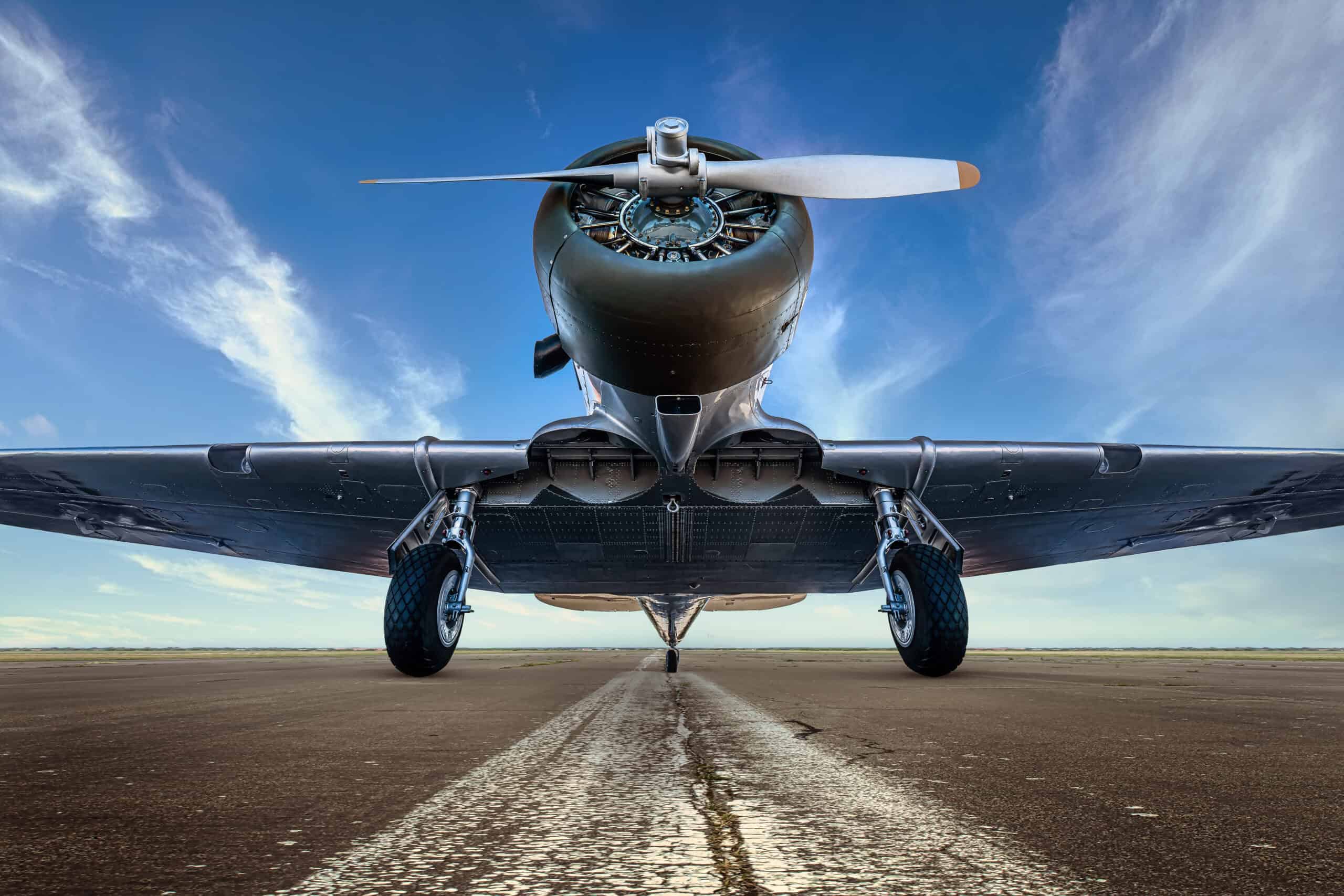 Vintage radial-engine aerobatic aircraft on runway
