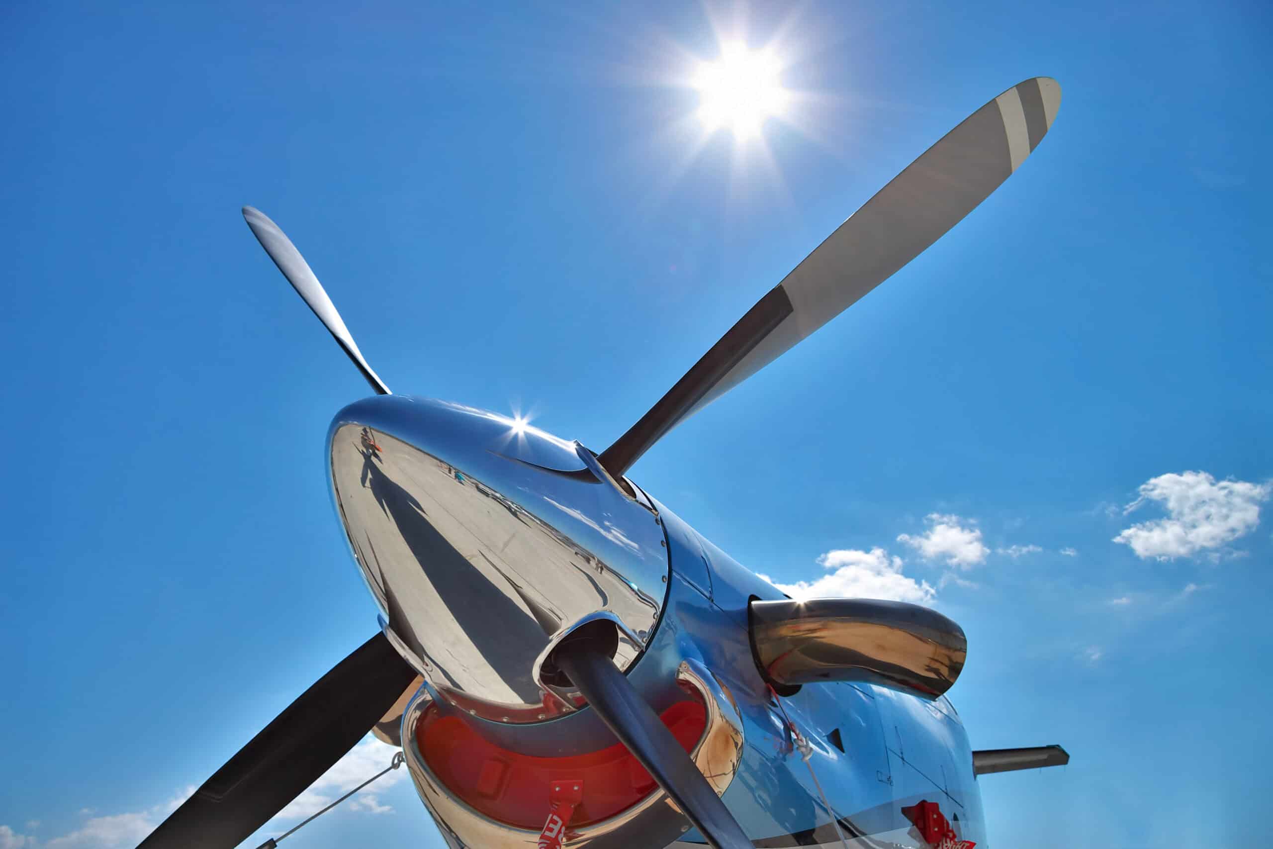 E3 Aviation Association aircraft propeller under bright blue sky.