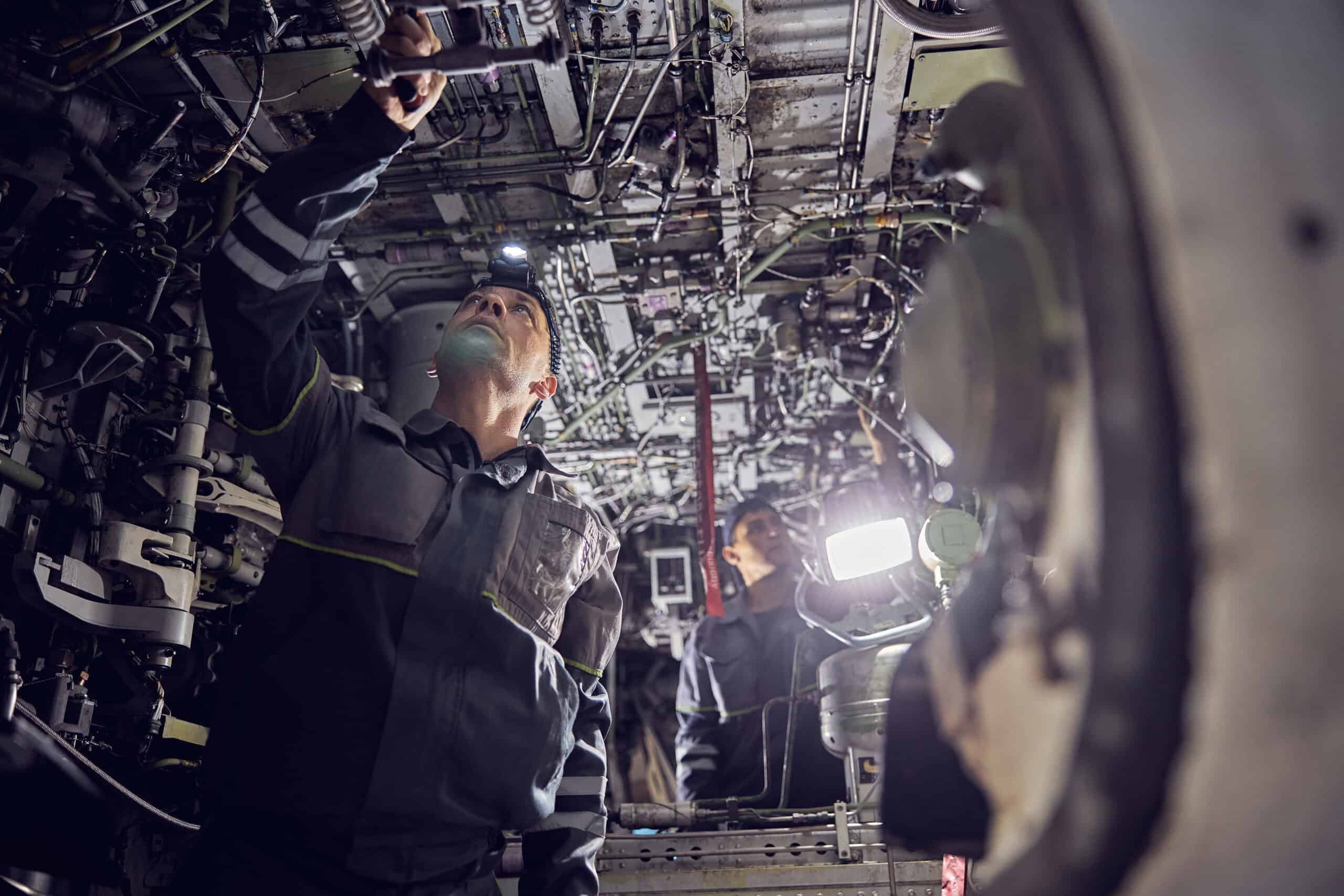 Aircraft worker repairing airplane showing GA aircraft ownership cost