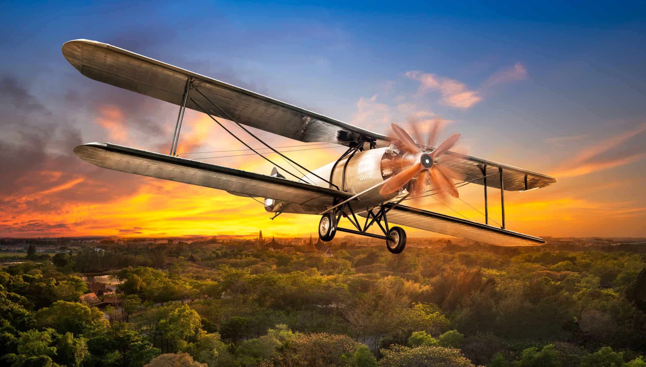 Small aircraft flying over rural landscape