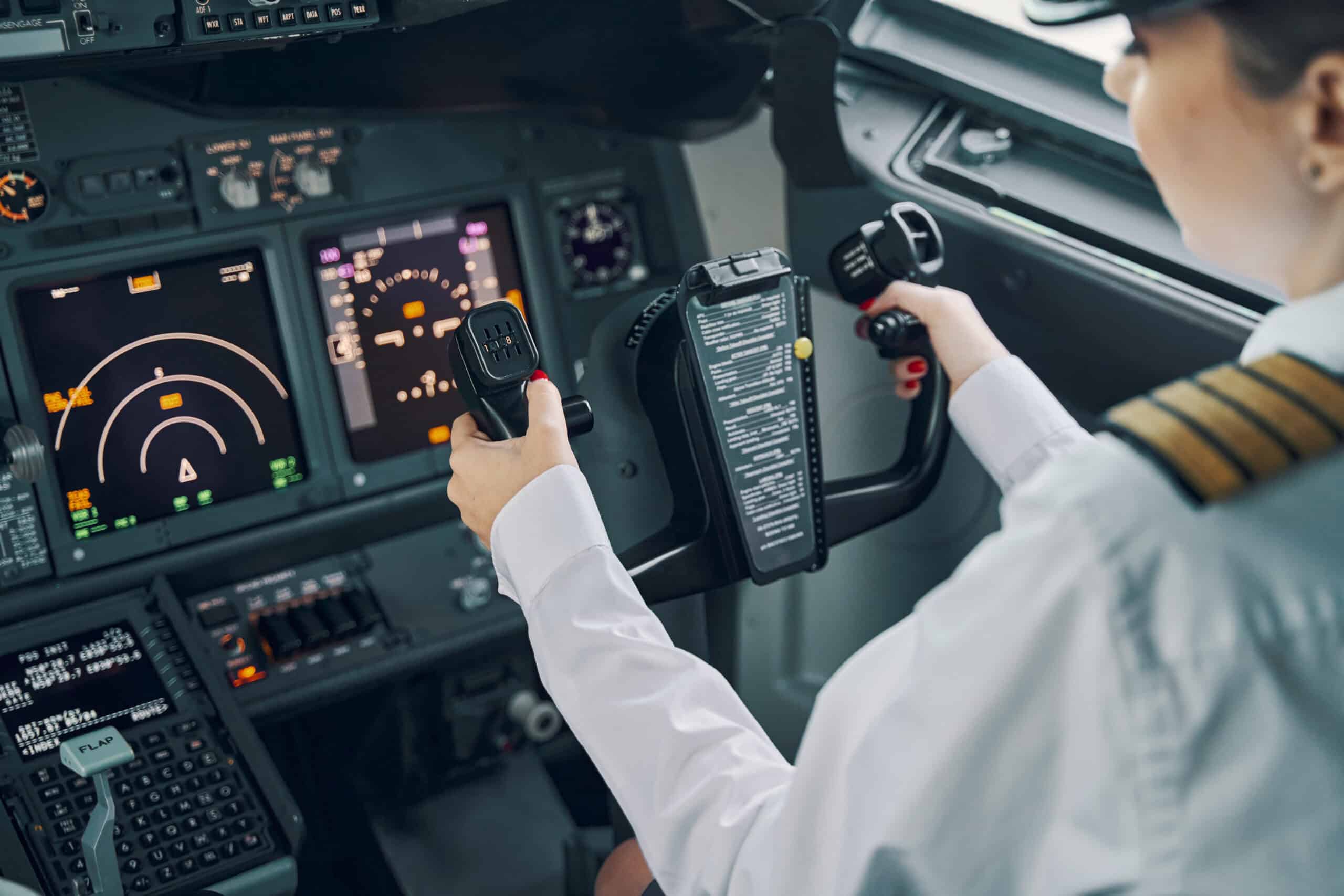 How to choose a flight instructor shown by female pilot navigating aircraft cockpit