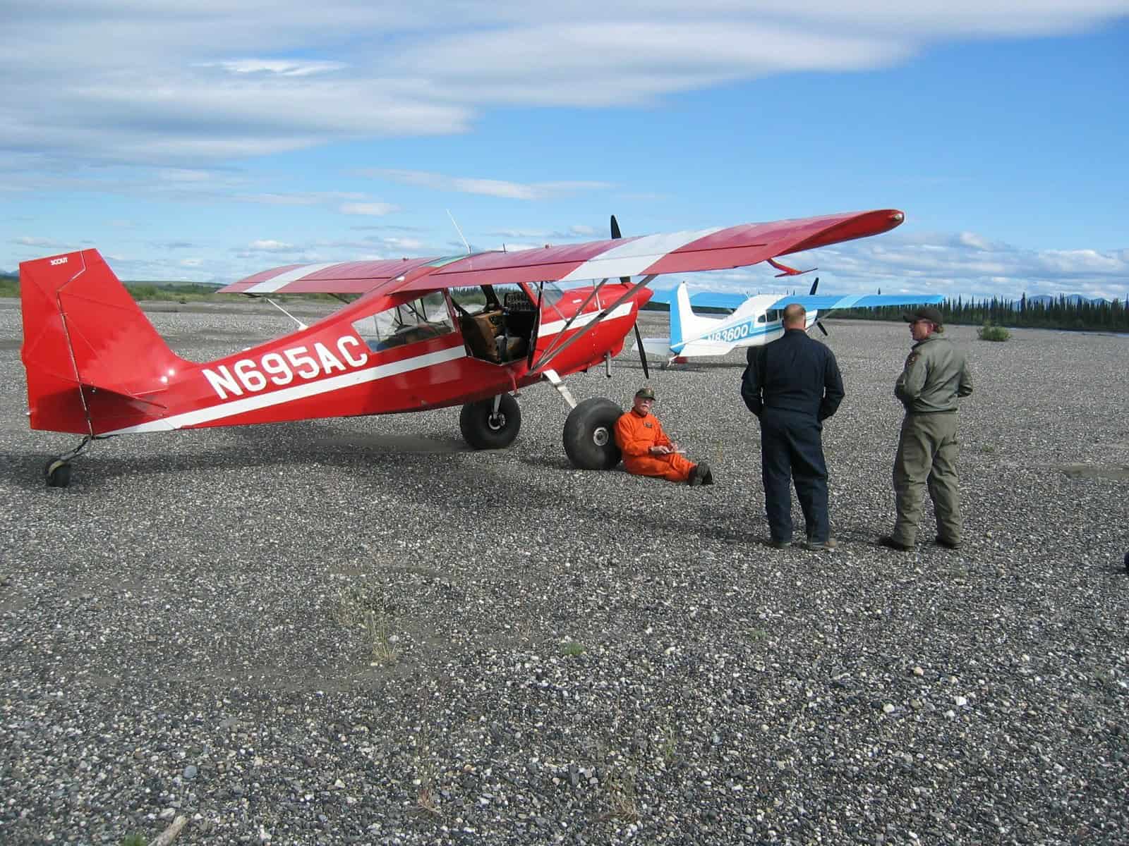 Backcountry pilots conferring on flight protocols before landing on an unimproved mountain strip