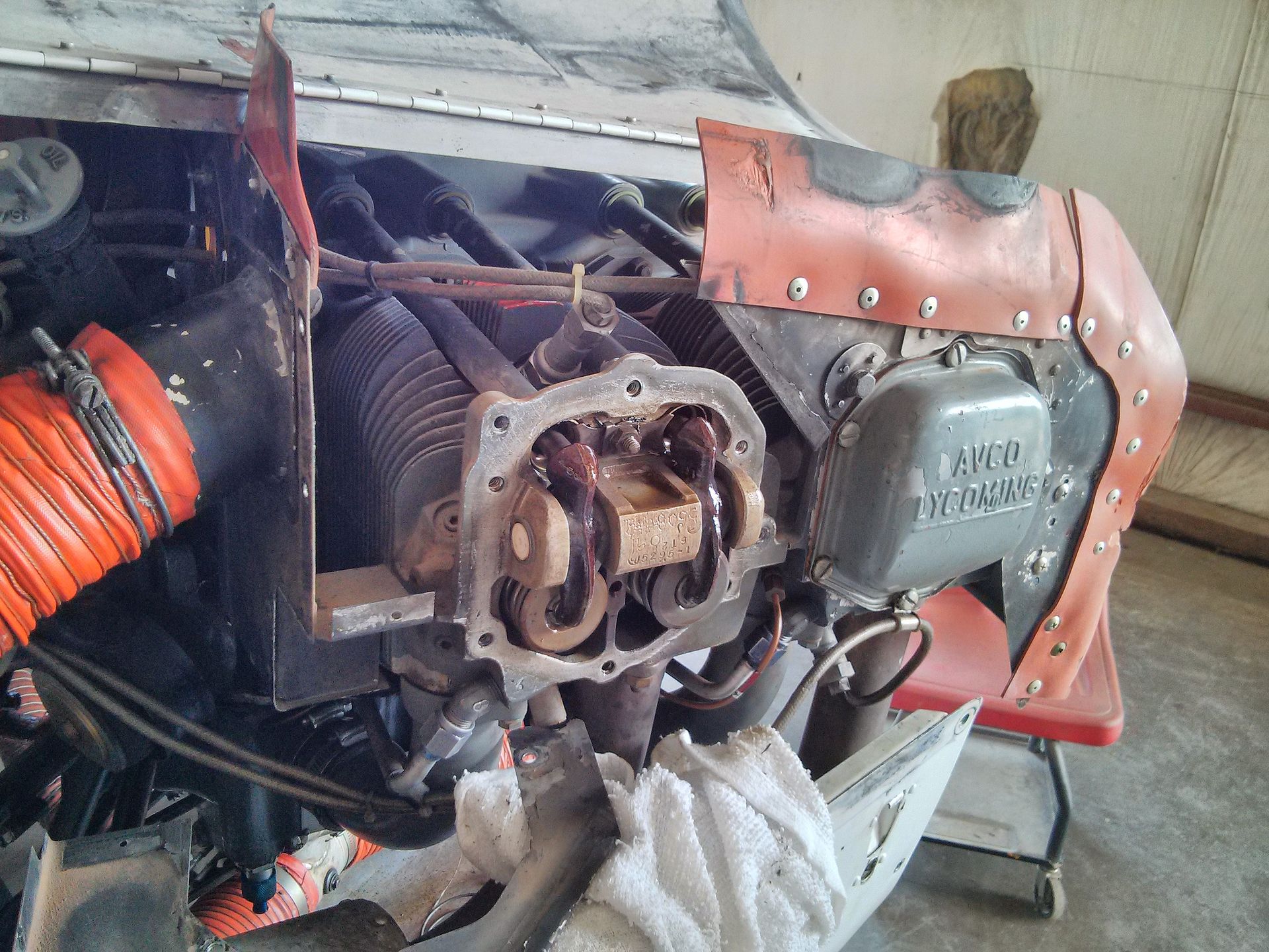 Lycoming O-320 cylinder with rocker cover removed showing valves — the area an aircraft cylinder compression test pinpoints when air leaks