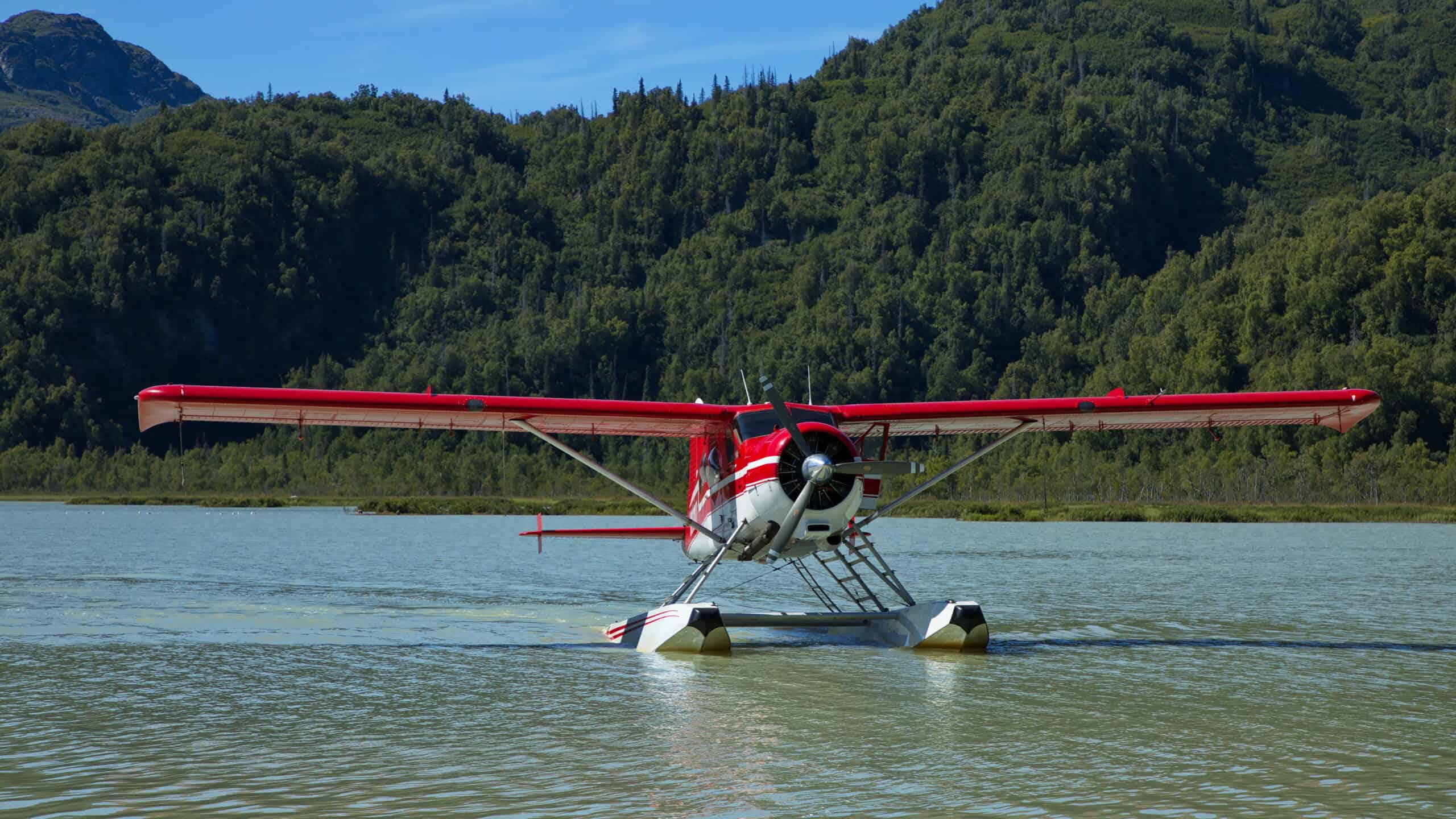 overwater flying safety — small Beaver floatplane on Alaska lake