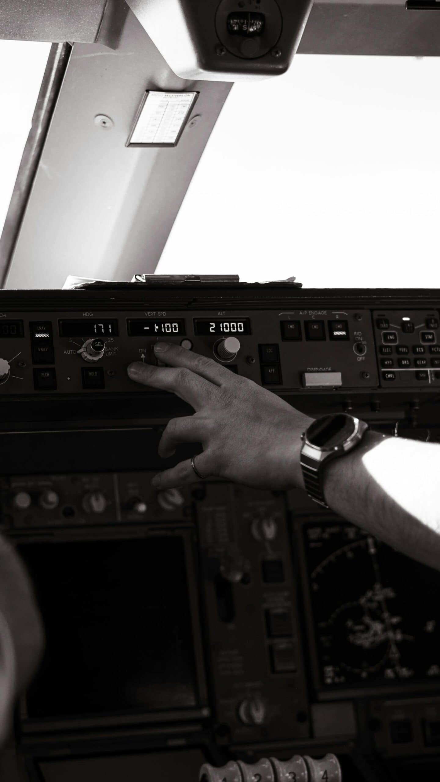 Pilot adjusting controls inside a general aviation cockpit