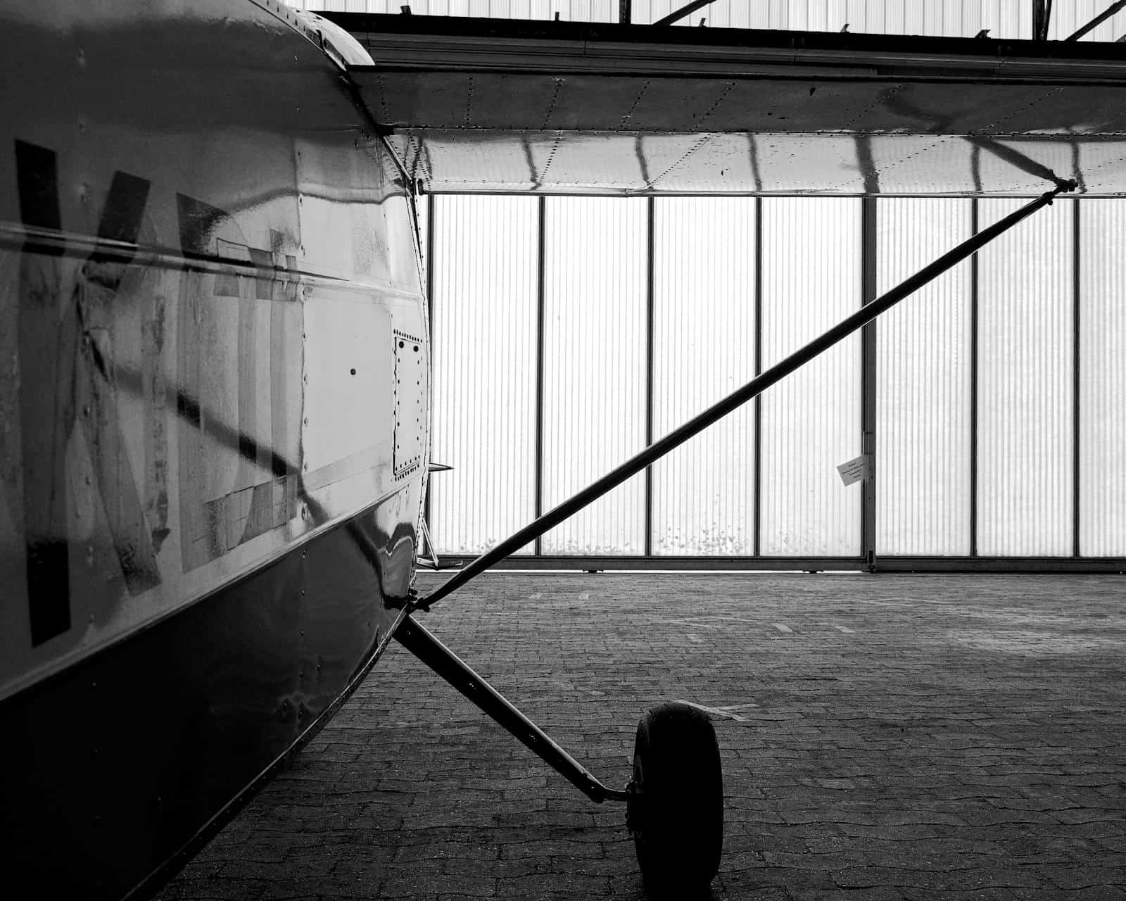 Aircraft tail visible inside an aircraft hangar
