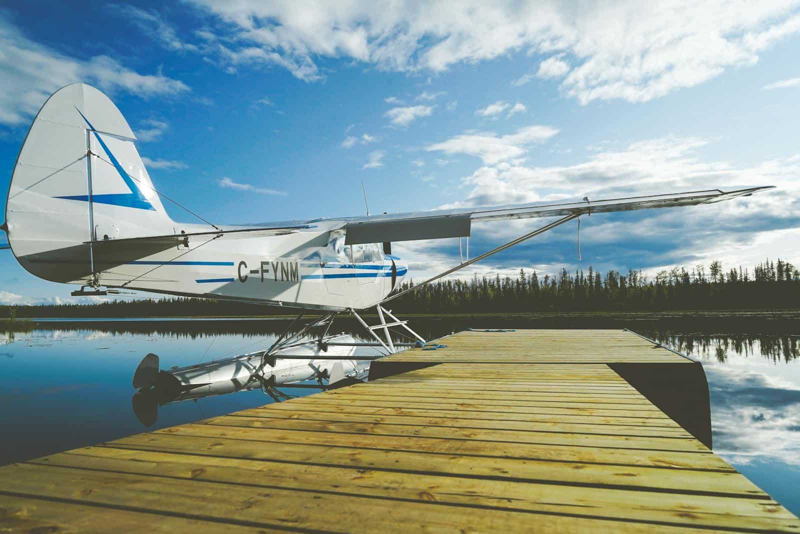 Seaplane moored at a wooden dock on a peaceful lake