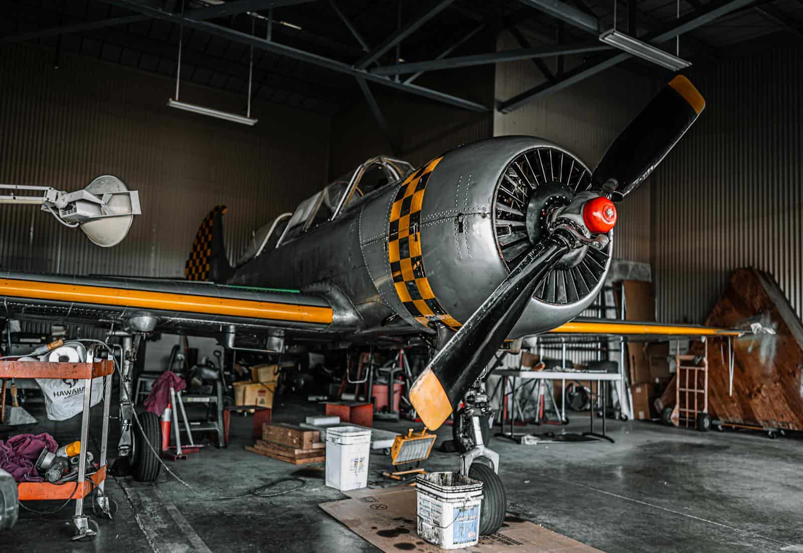 Vintage propeller aircraft staged for maintenance