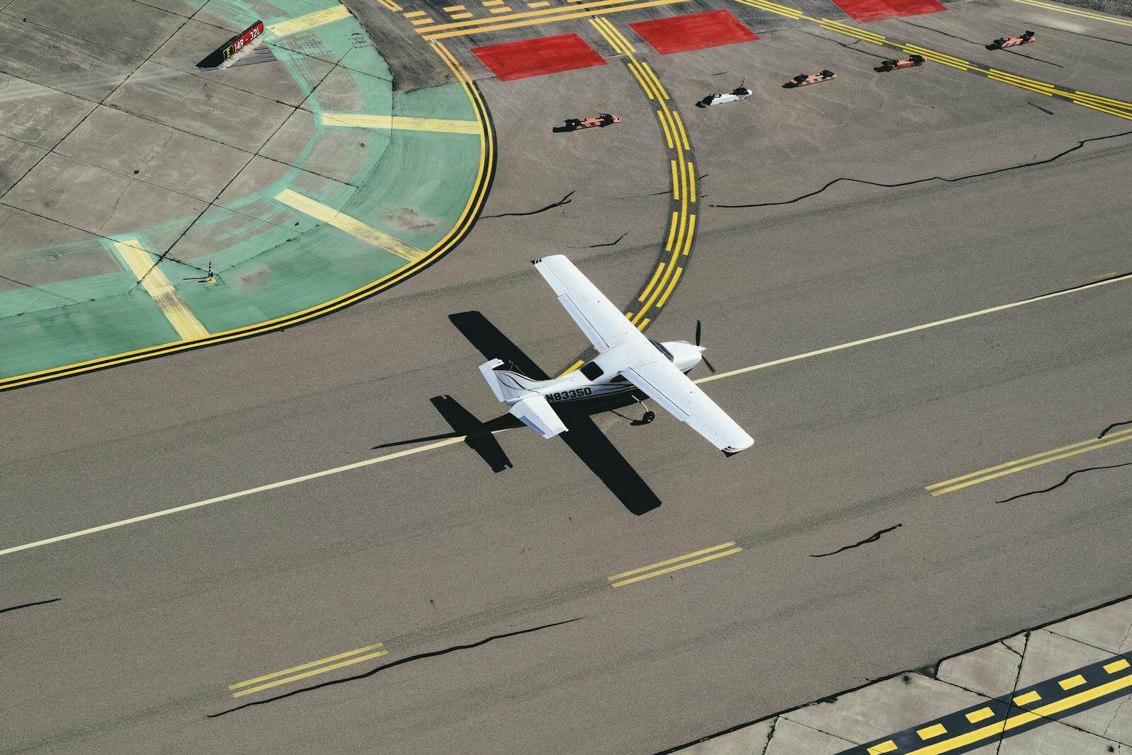 Biplane landing on a runway with yellow centerline markings