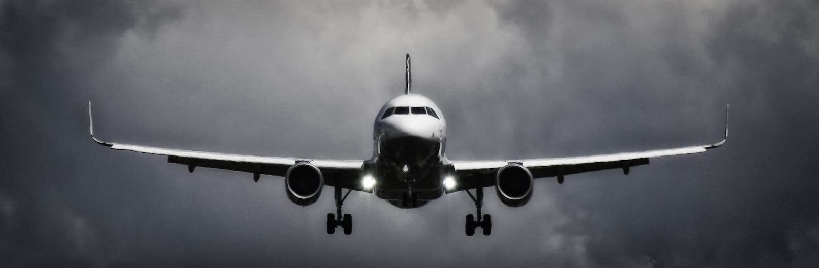 Aircraft landing under dramatic storm clouds