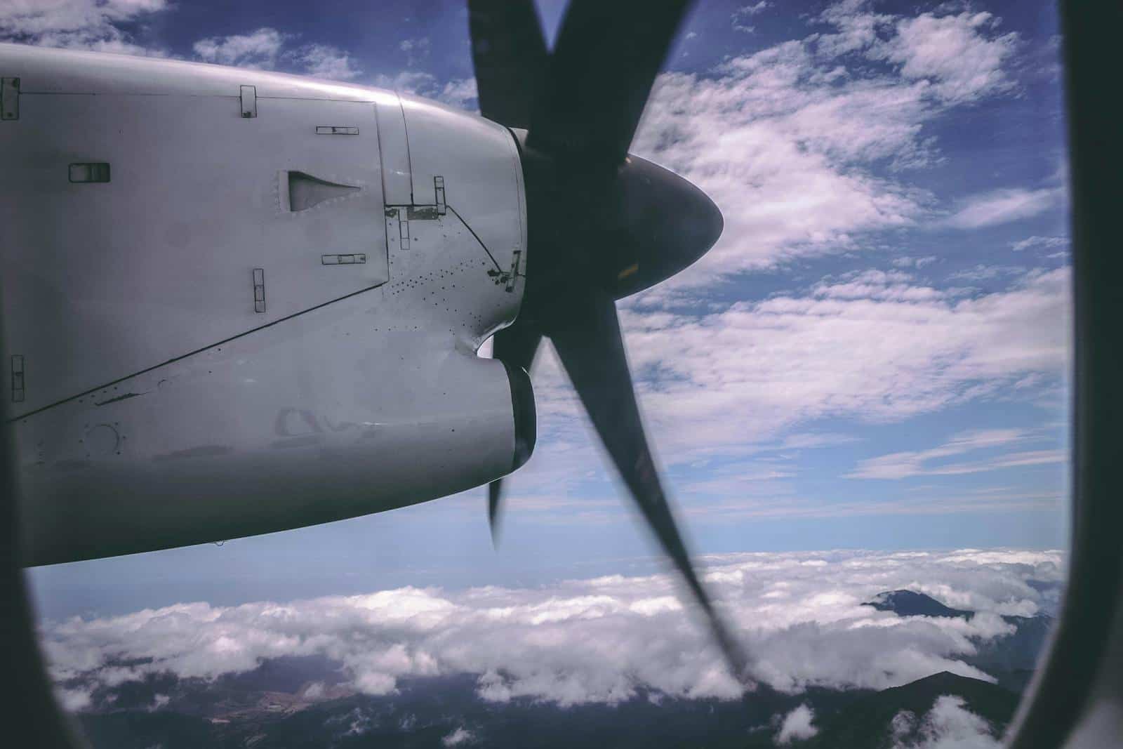 View through a general aviation propeller plane window during flight