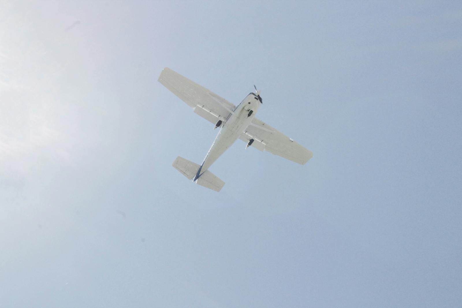 Private jet soaring high in the sky during daytime.