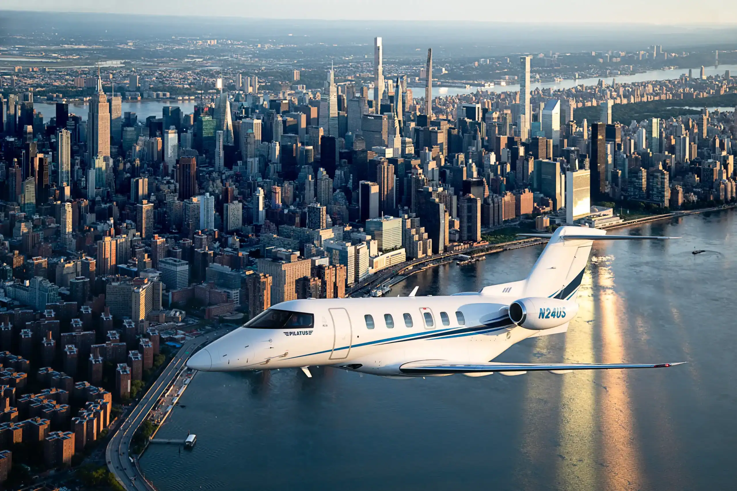 Private jet soaring above Manhattan with cityscape and river view.