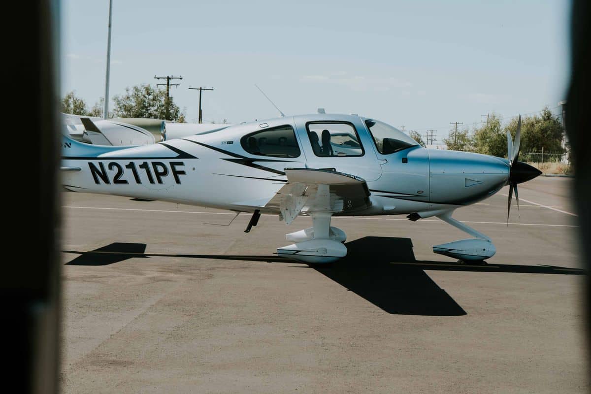 Cirrus aircraft parked on airport ramp showing composite airframe and CAPS placard