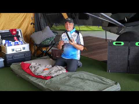 E3 Aviation host demonstrating the Born Outdoor airplane camping bedroll setup at a camping site next to the airplane.