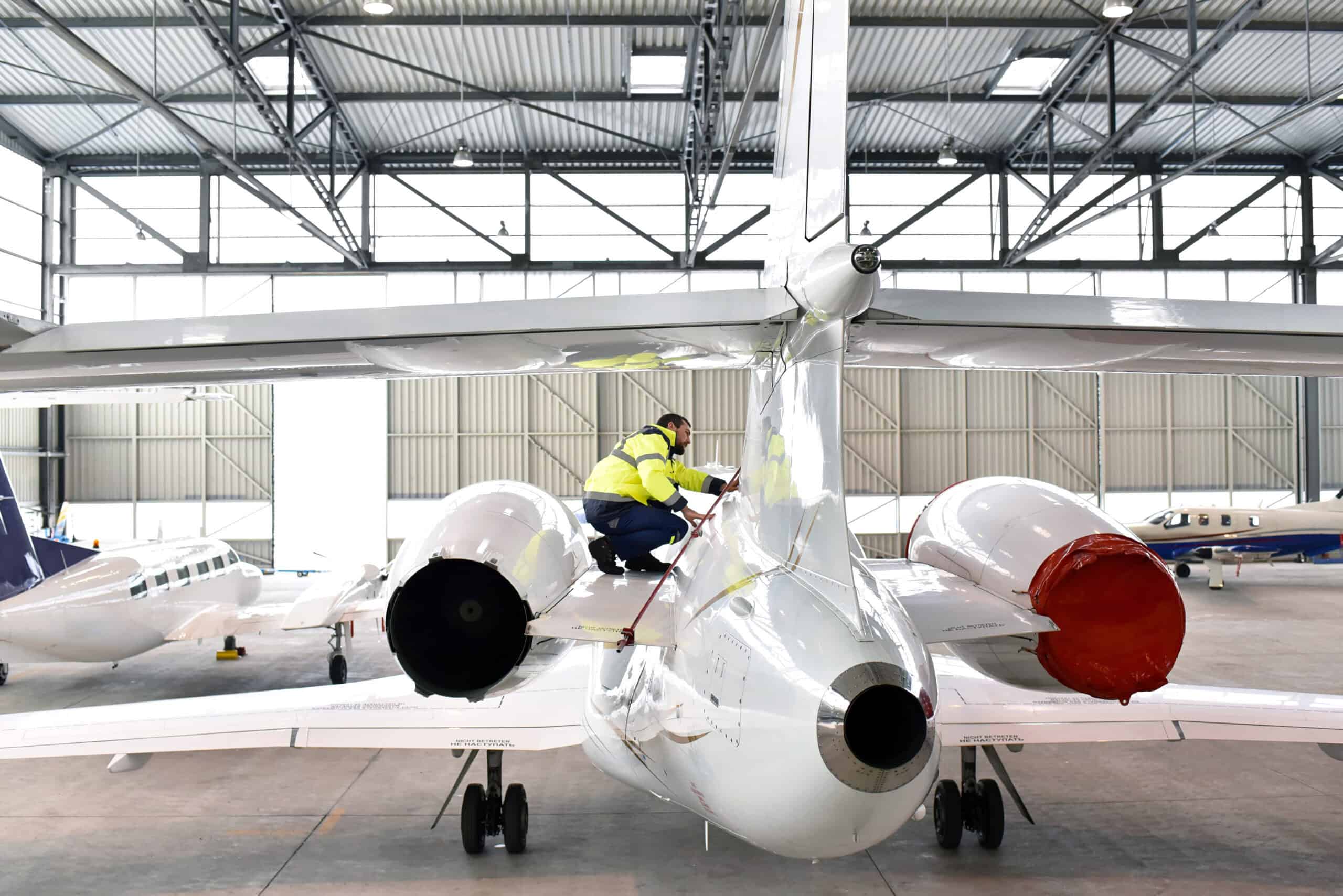 Avionics shop worker on aircraft in hangar - where the G3X Touch retrofit labor cost lives