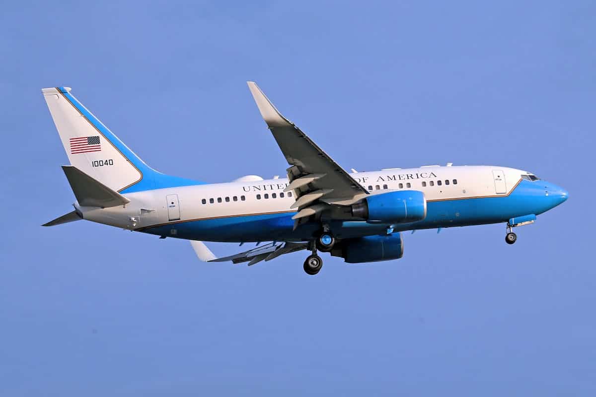 Air Force One aircraft flying in clear blue sky.