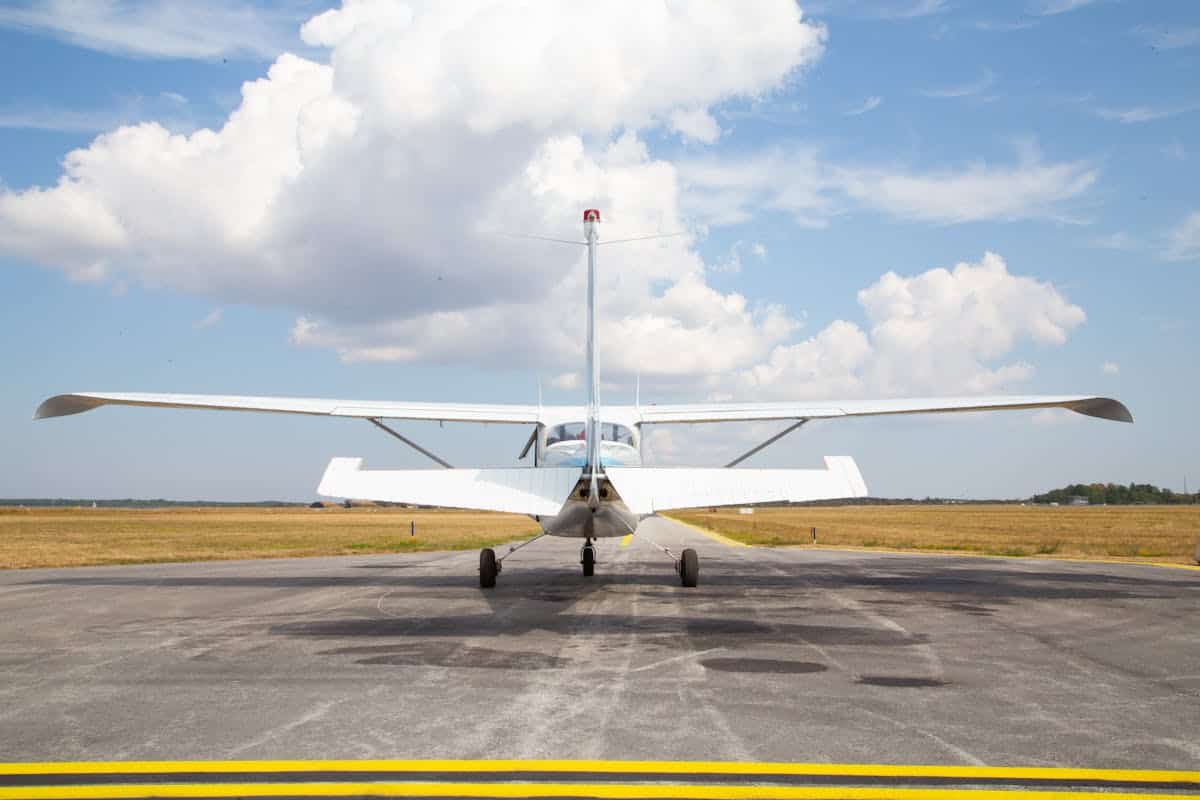 Rear view of small aircraft on a sunny runway
