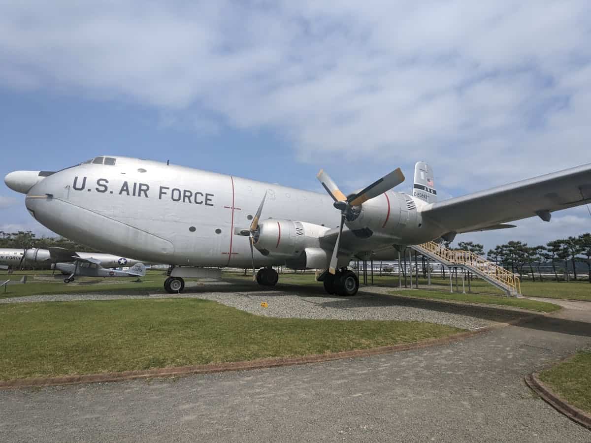 U.S. Air Force aircraft displayed outdoors with stairs and grassy area.