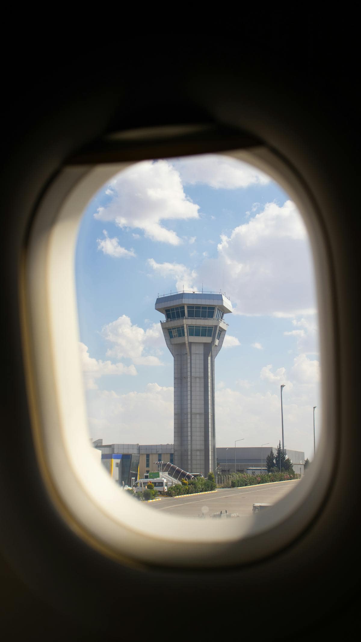 Air traffic control tower viewed through an airplane window