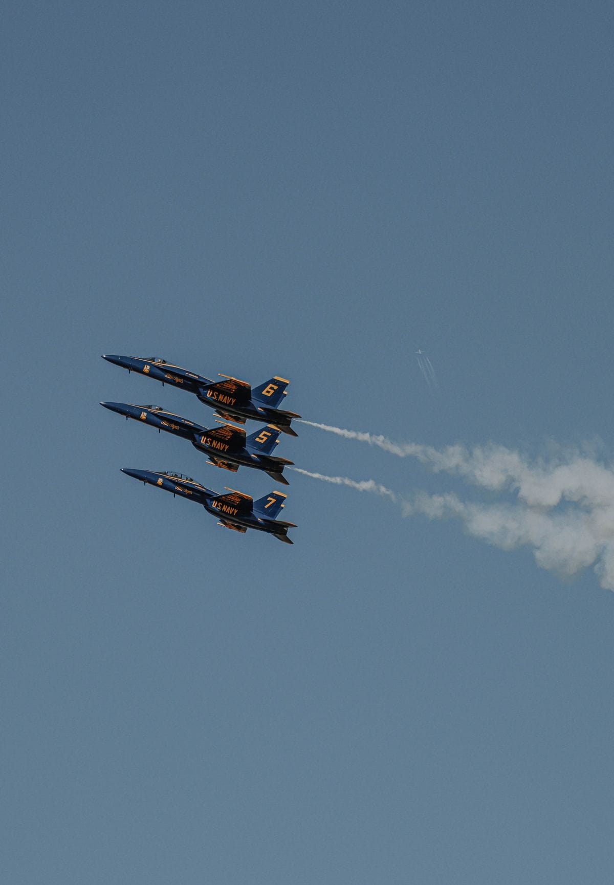 F-16 fighter jets flying in tight formation during an airshow.