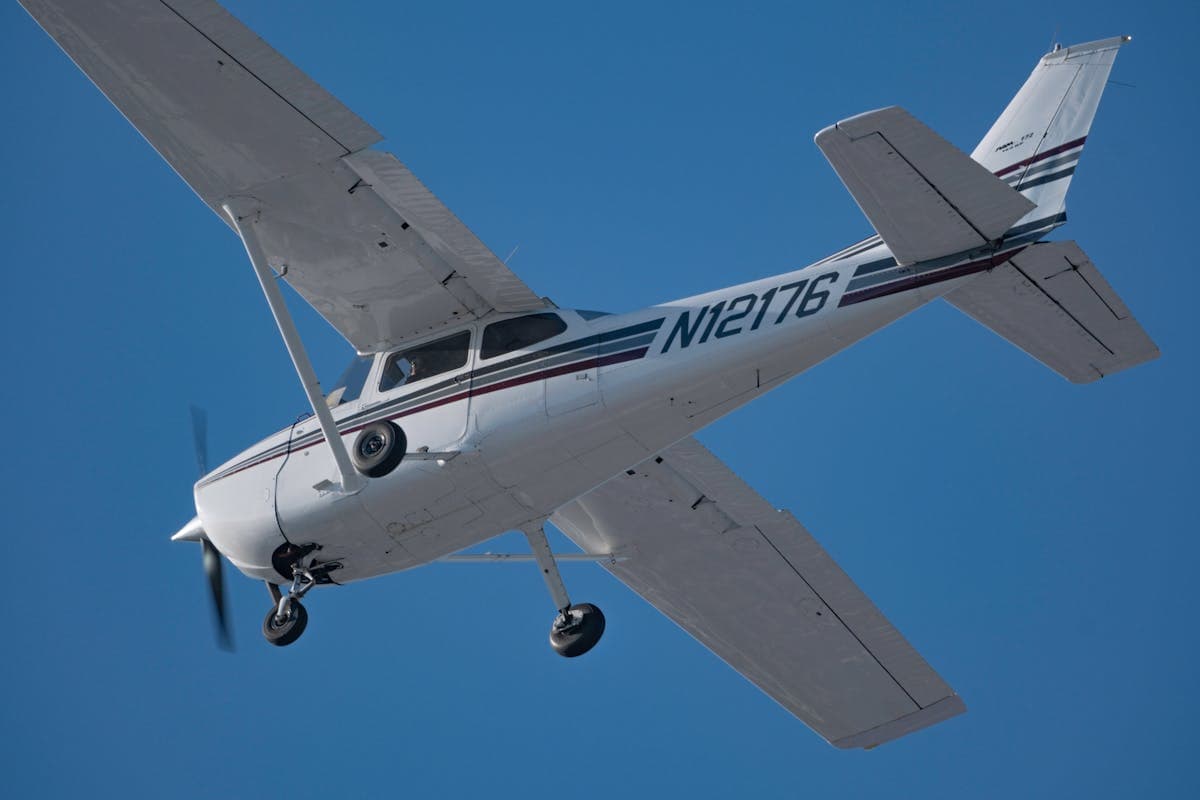 Small aircraft flying high in clear sky