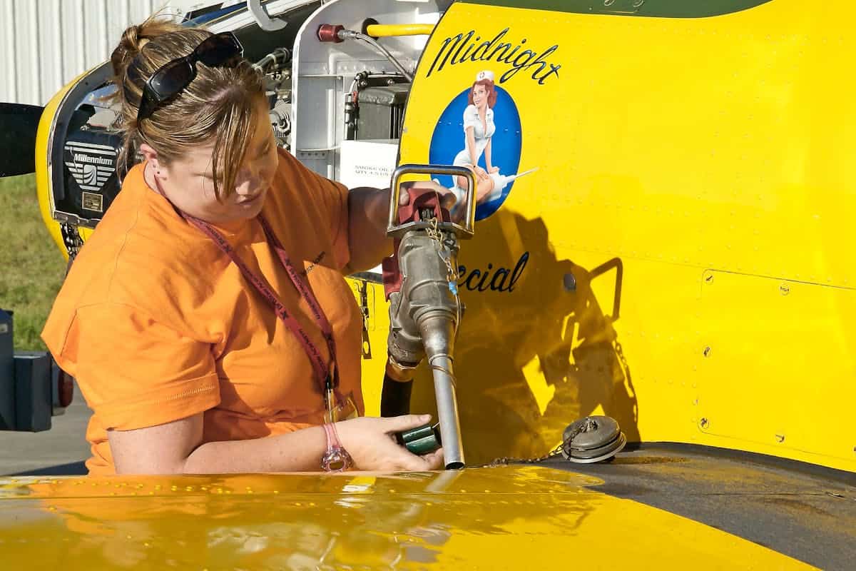 Pilot refueling a vintage general aviation airplane