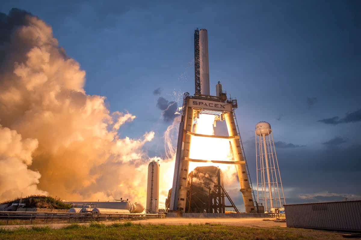 SpaceX rocket launch against a colorful dusk sky
