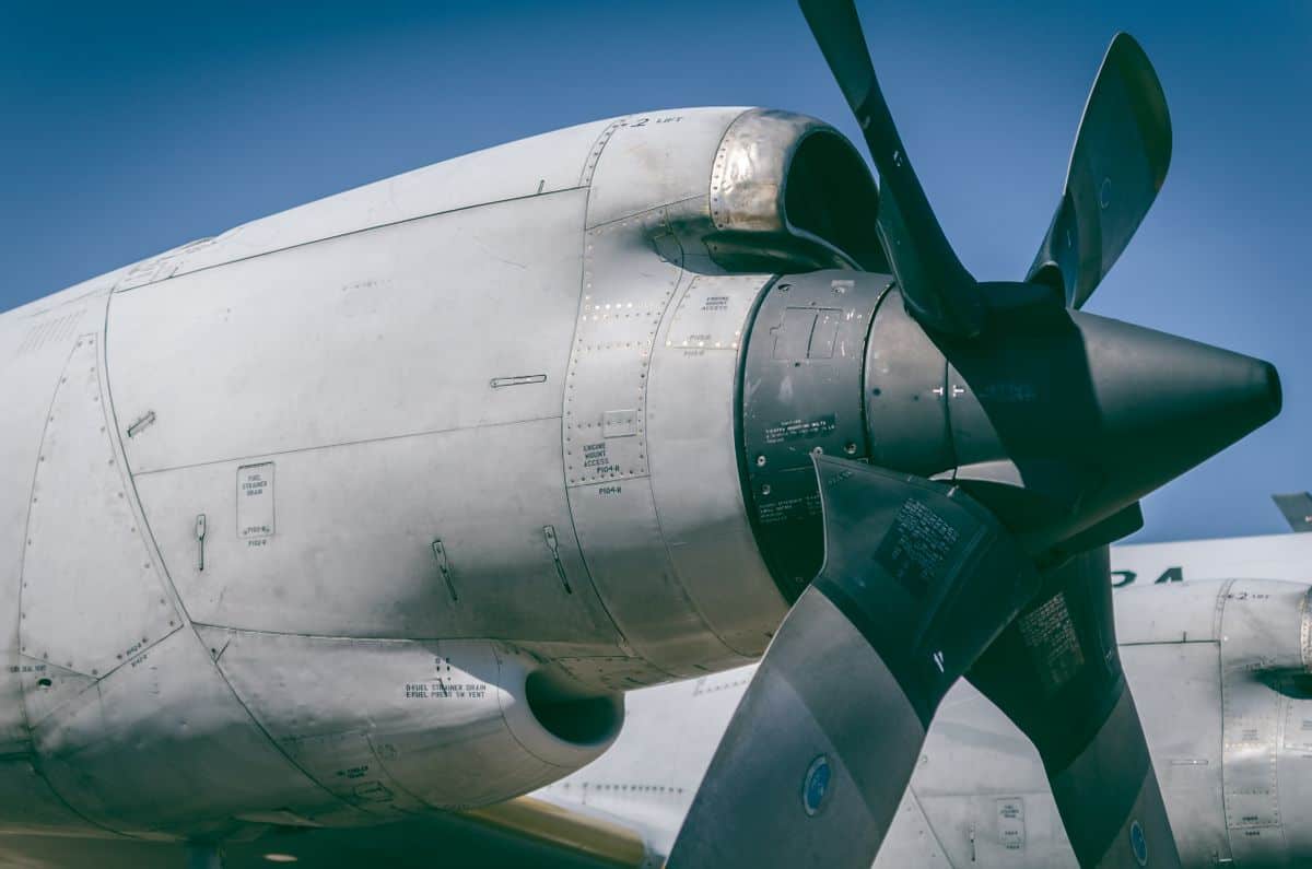 Vintage aircraft propeller and engine with a clear blue sky