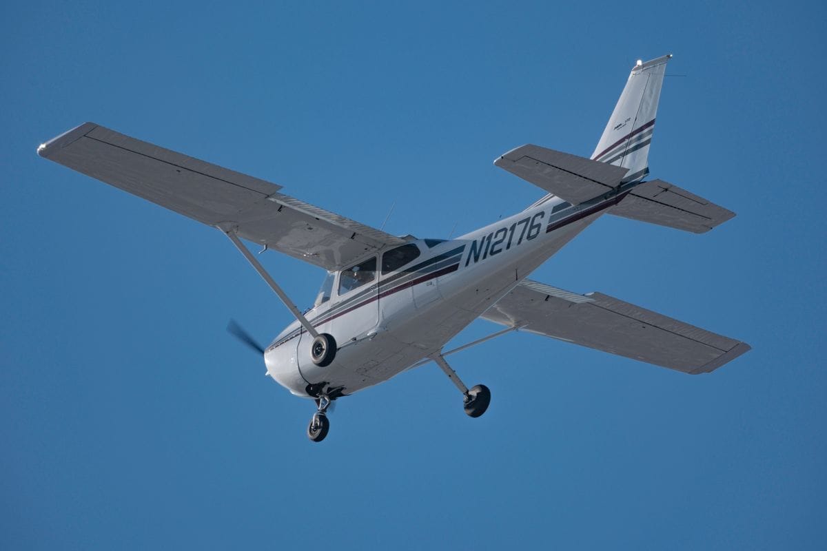Small private GA airplane in flight illustrating mid-air collision avoidance see-and-avoid principle