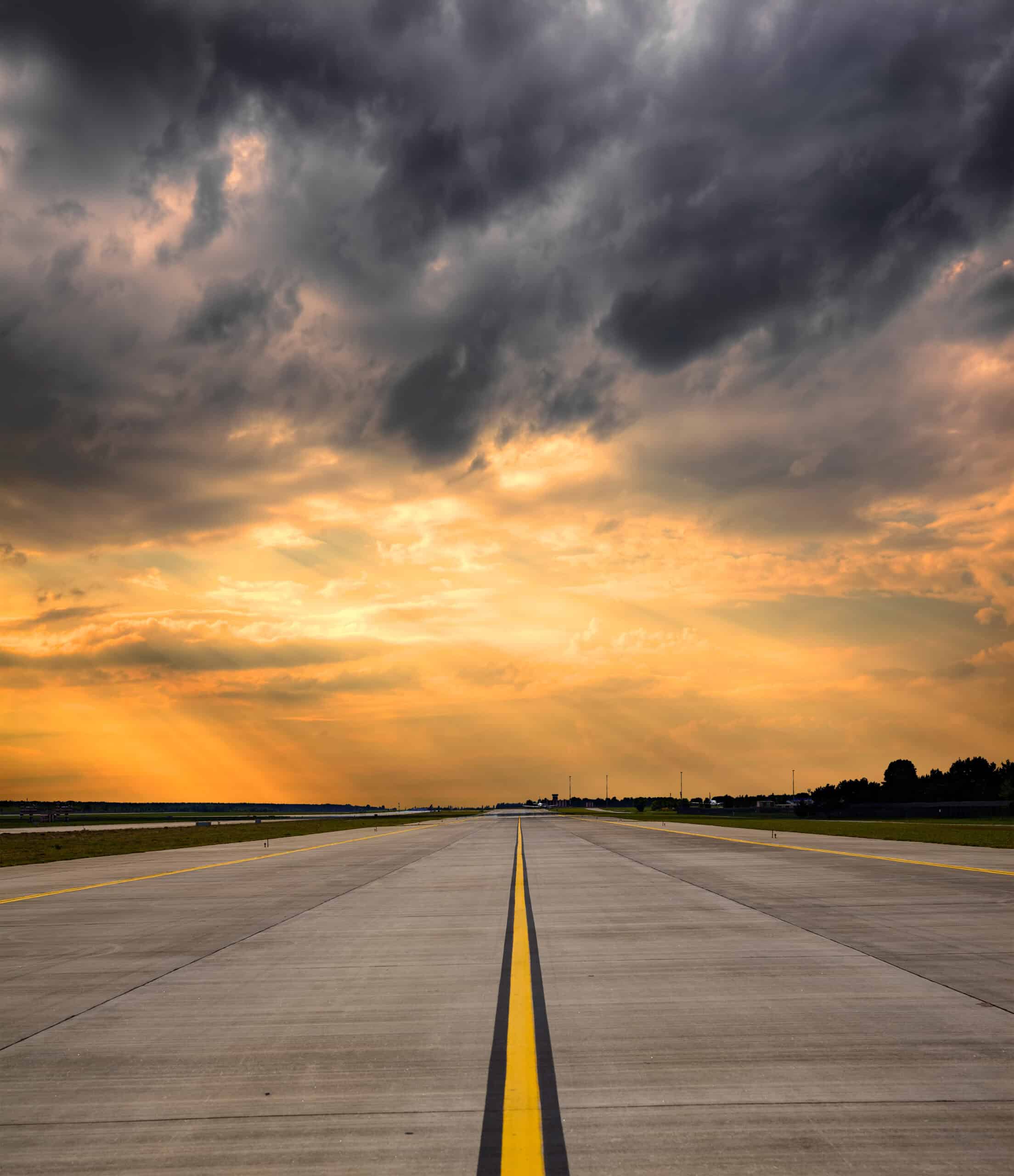 Empty runway under dramatic sky — VFR cross-country planning starts with the route