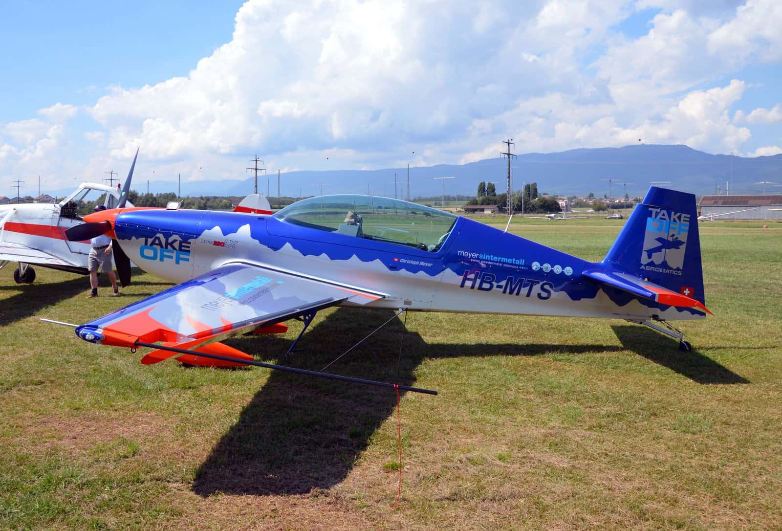 Modern GA aerobatic single — an Extra 300 on grass, where today's pilots practice the energy management Hoover made famous.
