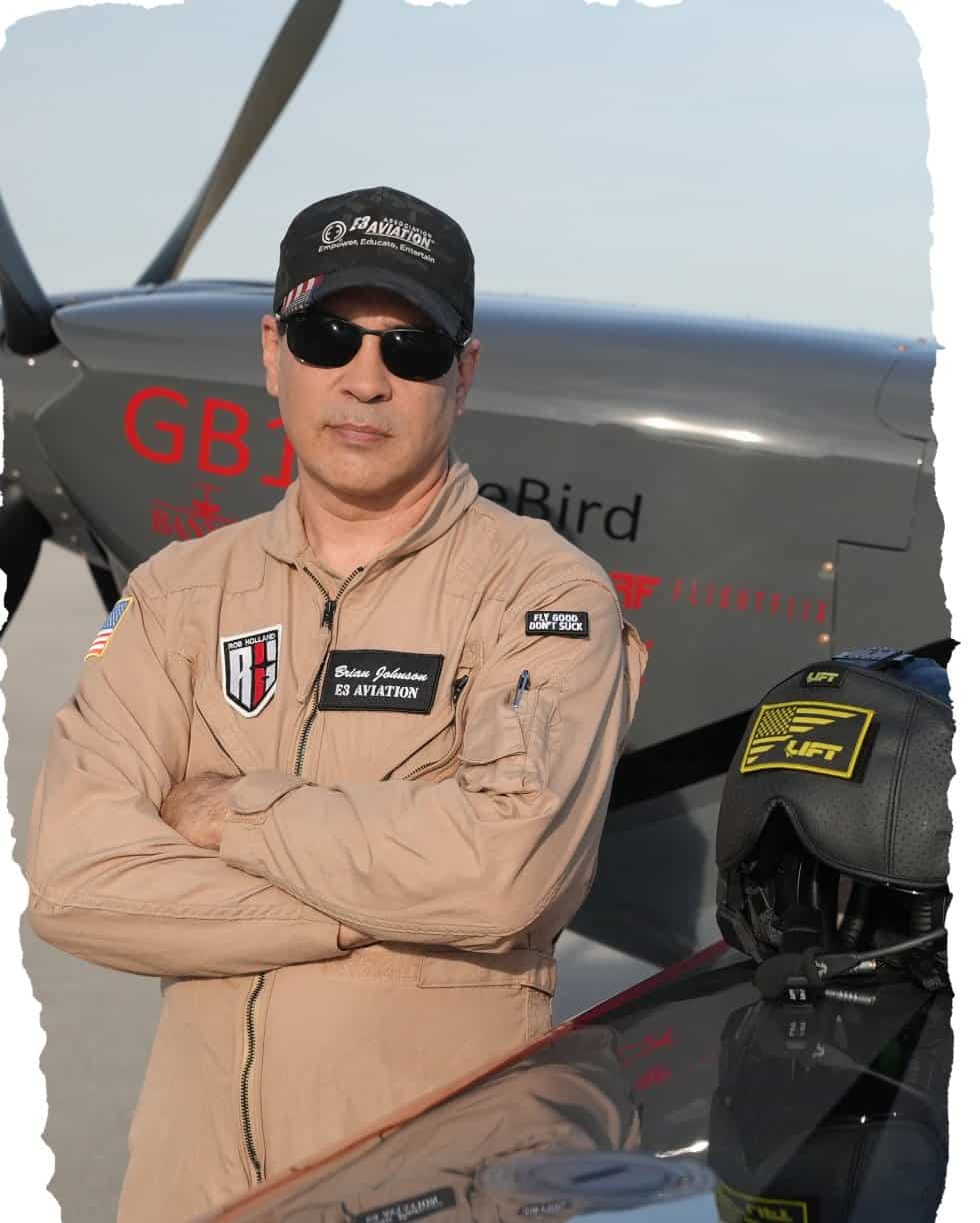 Aviation pilot in uniform with aircraft in background.