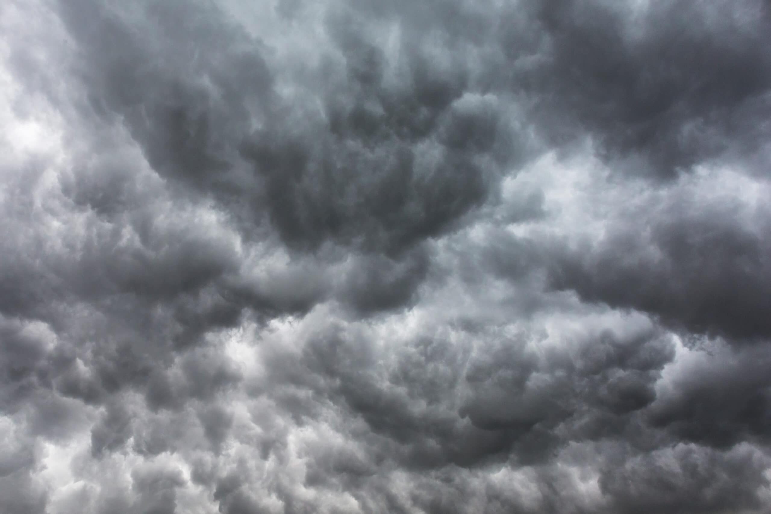 Dark storm clouds fill the sky, indicating an approaching storm.