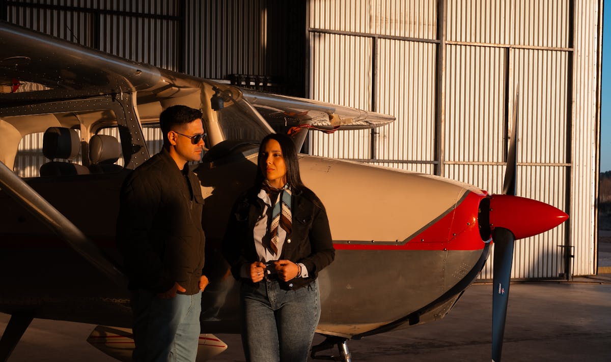 Aircraft owner standing next to a Cessna 172 in a grass airfield